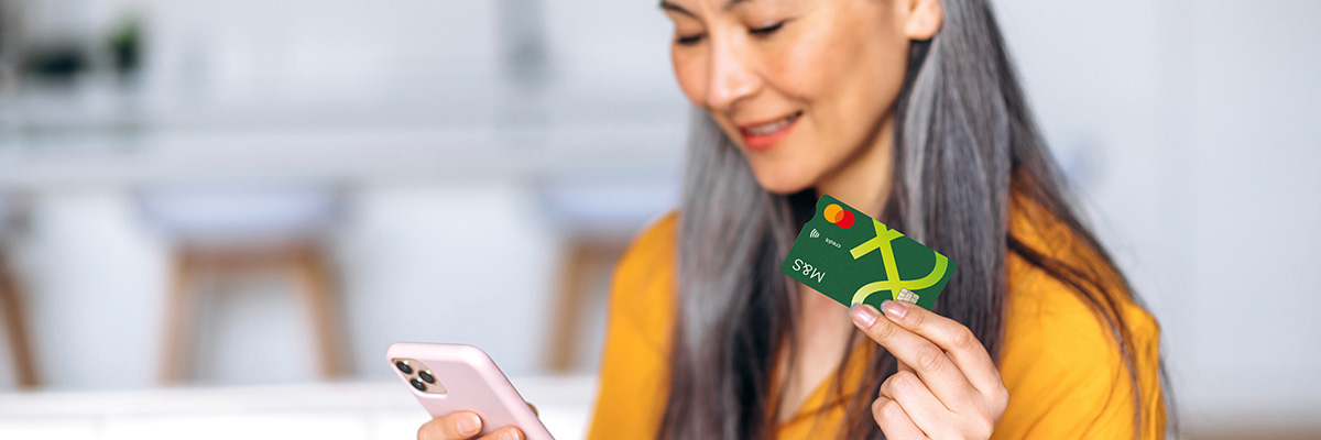 Person holding phone and card