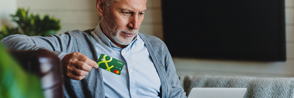 Person sitting holding Credit Card