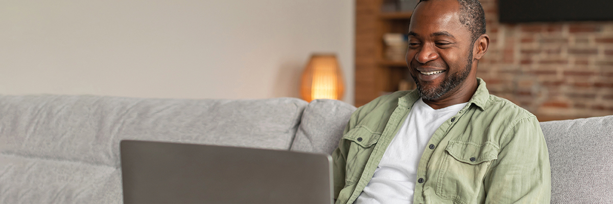 Person sitting on sofa with laptop