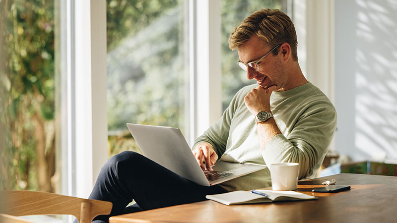 Person sitting at table with laptop