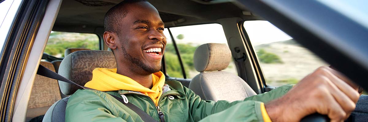 Smiling person driving car