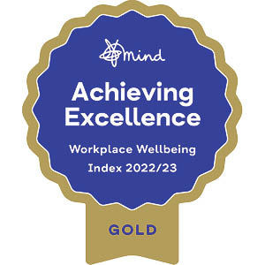 Rosette showing a gold award from Mind for achieving excellence in the workplace wellbeing index 2022/23